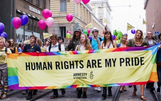 Ihmisiä Pride-kulkueessa